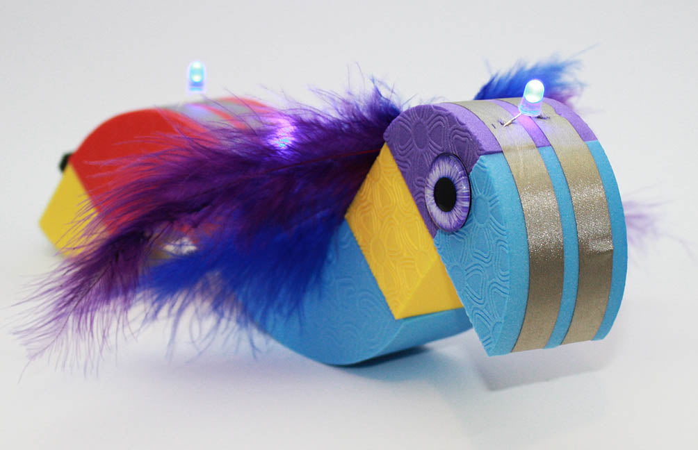 A long character with wings and several blue LEDs done its back.