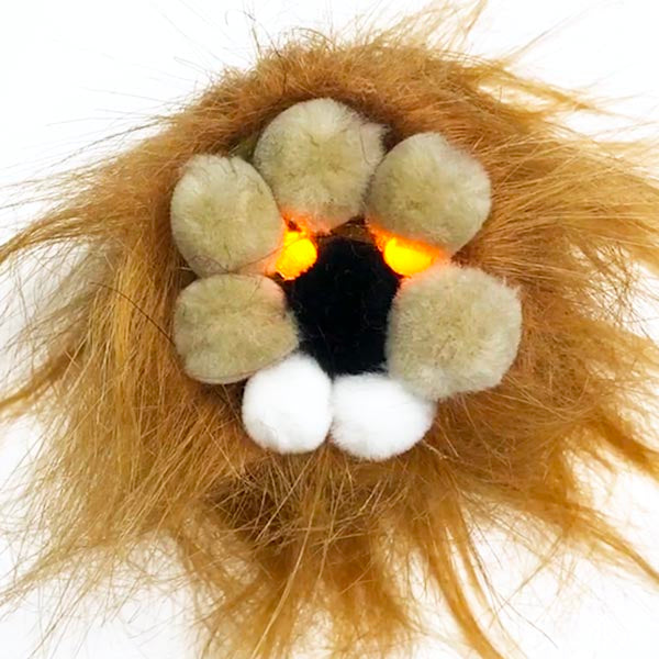 A pom pom lion with fur mane head. Yellow light up eyes and a black nose