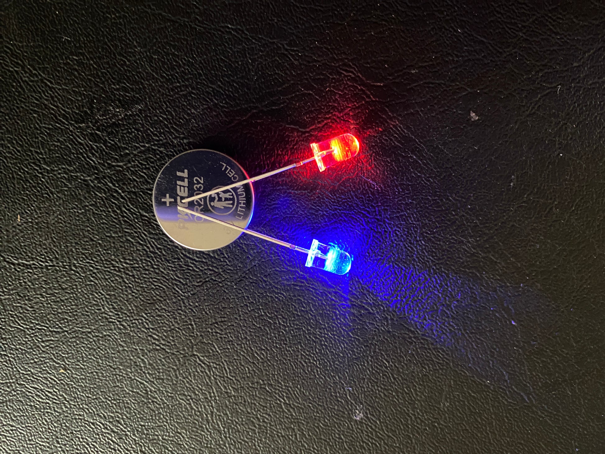 Red and Blue flashing LEDs with the legs on a 3V battery