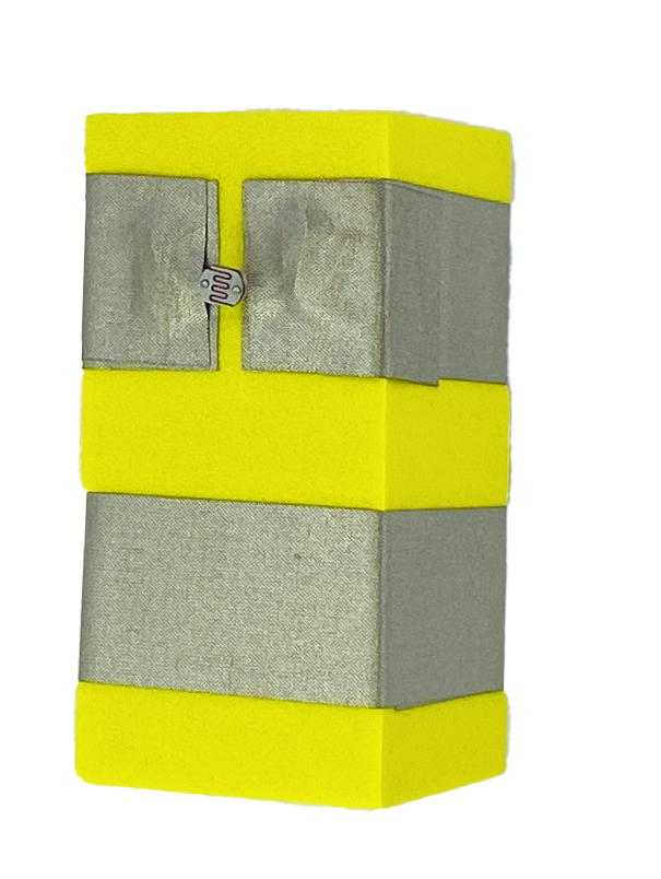 A yellow foam block with two parallel rows of conductive tape wrapped around it. The top layer of tape has a gap in it and in the gap is a Light Dependent Resistor. 