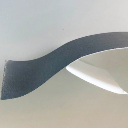 A short length of conductive tape with an inch of the silver conductive tape separated from the white backing